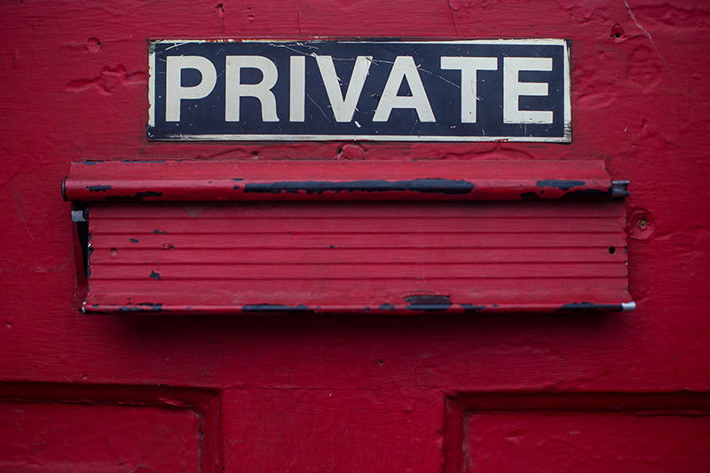 A red door with the word private on it